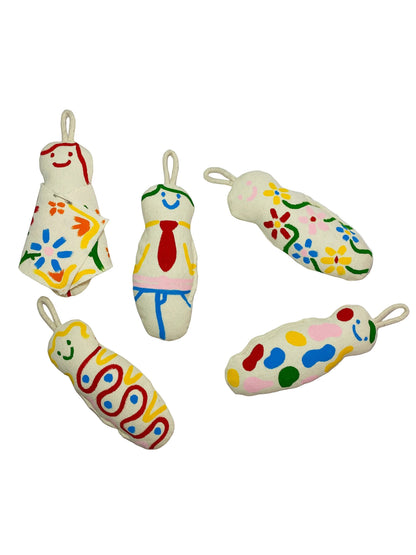 Jose Ibarra Estudio handmade stuffed keychains with hand-painted abstract designs and smiley faces on thick cotton canvas.