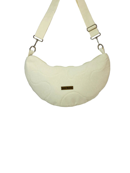 Jose Ibarra Luna cream canvas crescent bag with hand-painted details and adjustable strap.
