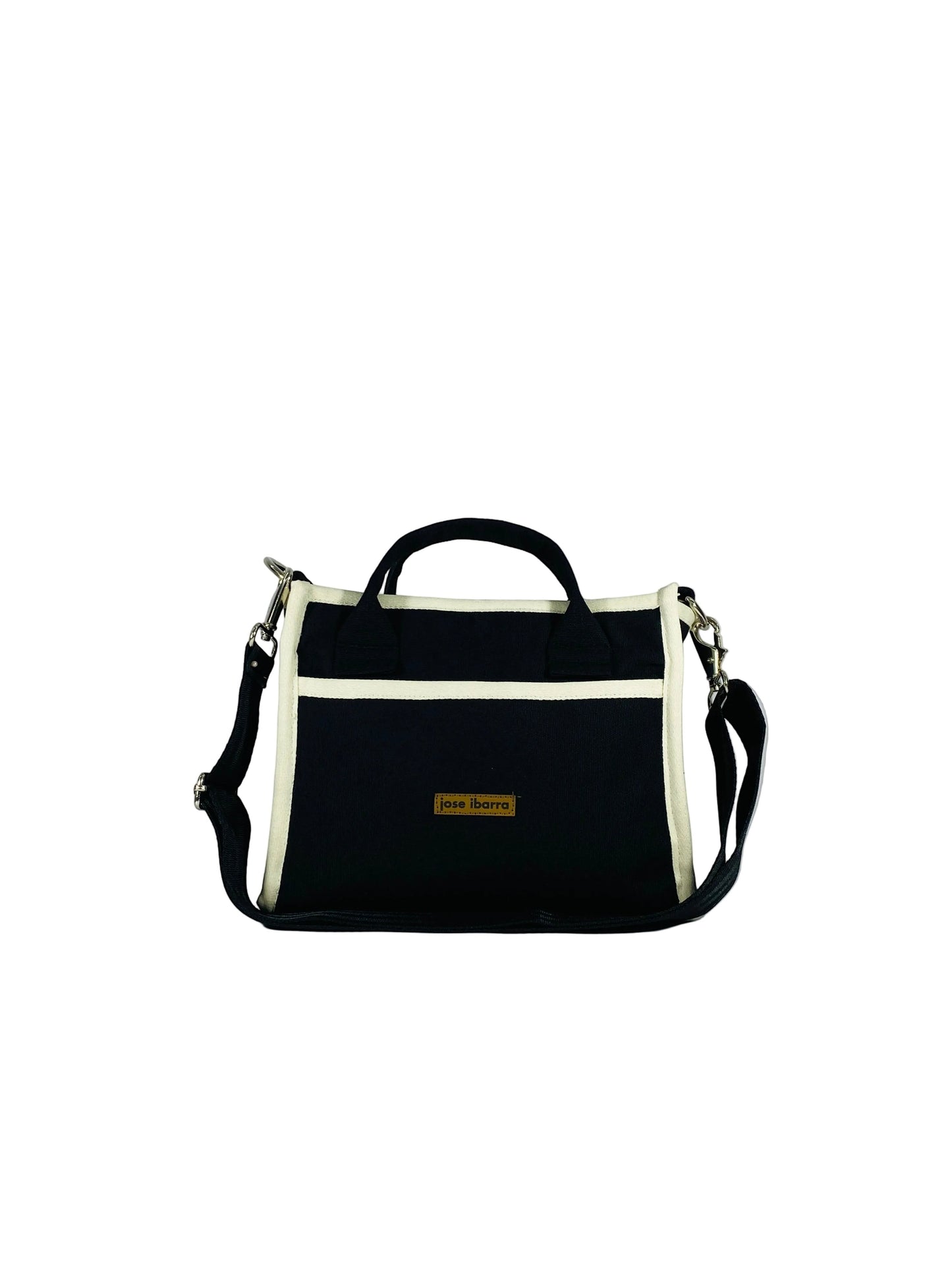 Jose Ibarra Estudio navy blue thick canvas tote bag with cream trim and adjustable strap. Features internal pockets and a brand logo tag.