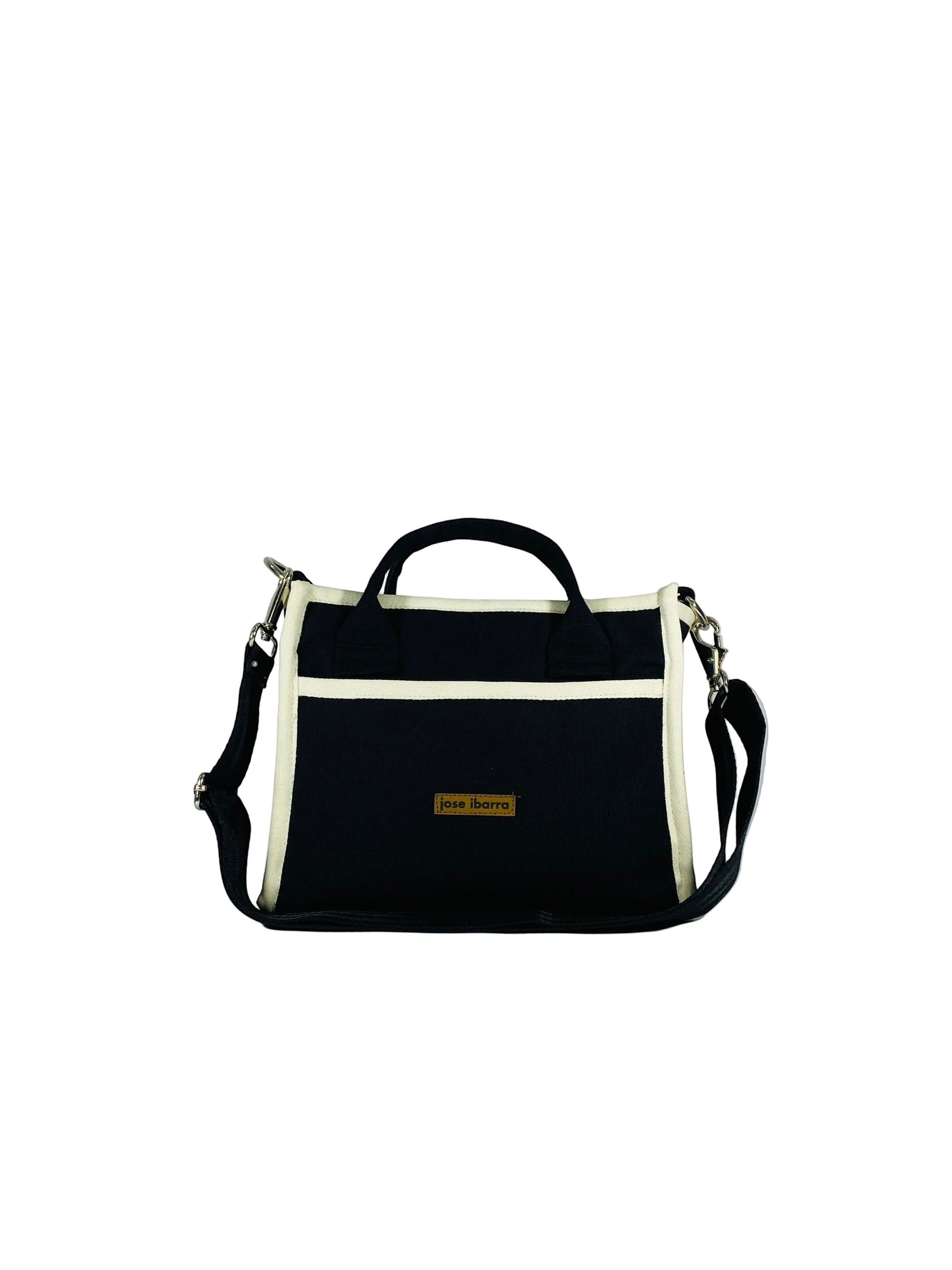 Jose Ibarra Estudio navy blue thick canvas tote bag with cream trim and adjustable strap. Features internal pockets and a brand logo tag.