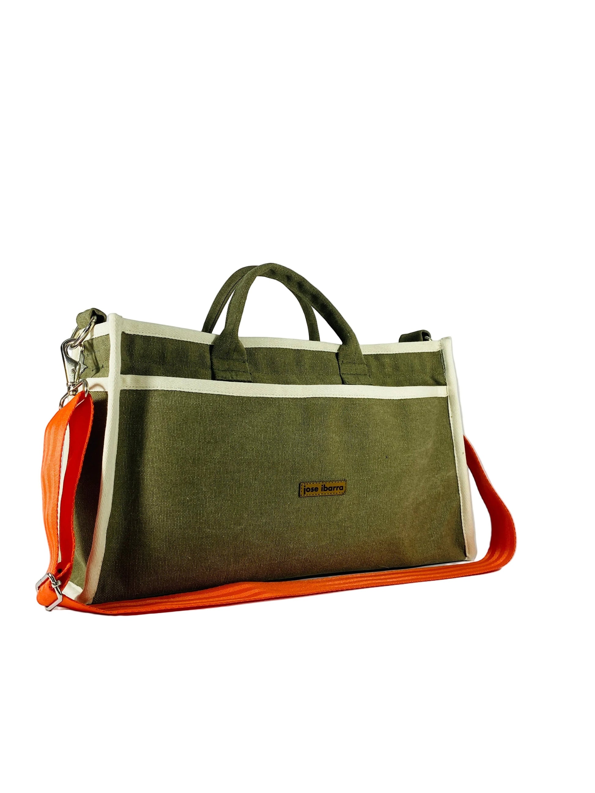 Jose Ibarra Estudio olive green canvas tote bag with cream trim and orange straps, internal pockets, includes strap.
