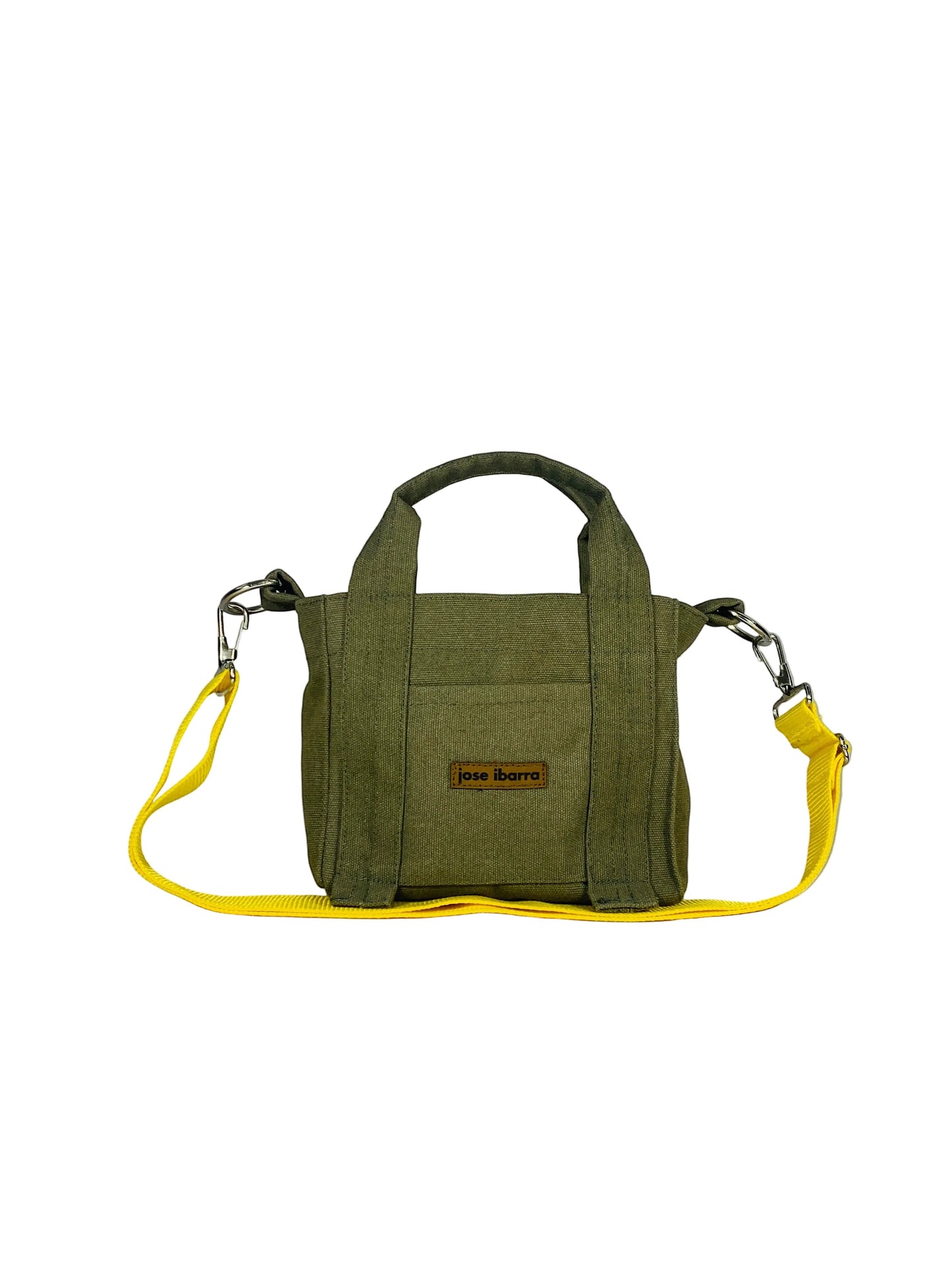 Jose Ibarra Estudio olive green canvas tote bag with yellow strap, hand-painted design, internal pockets, and top handles.