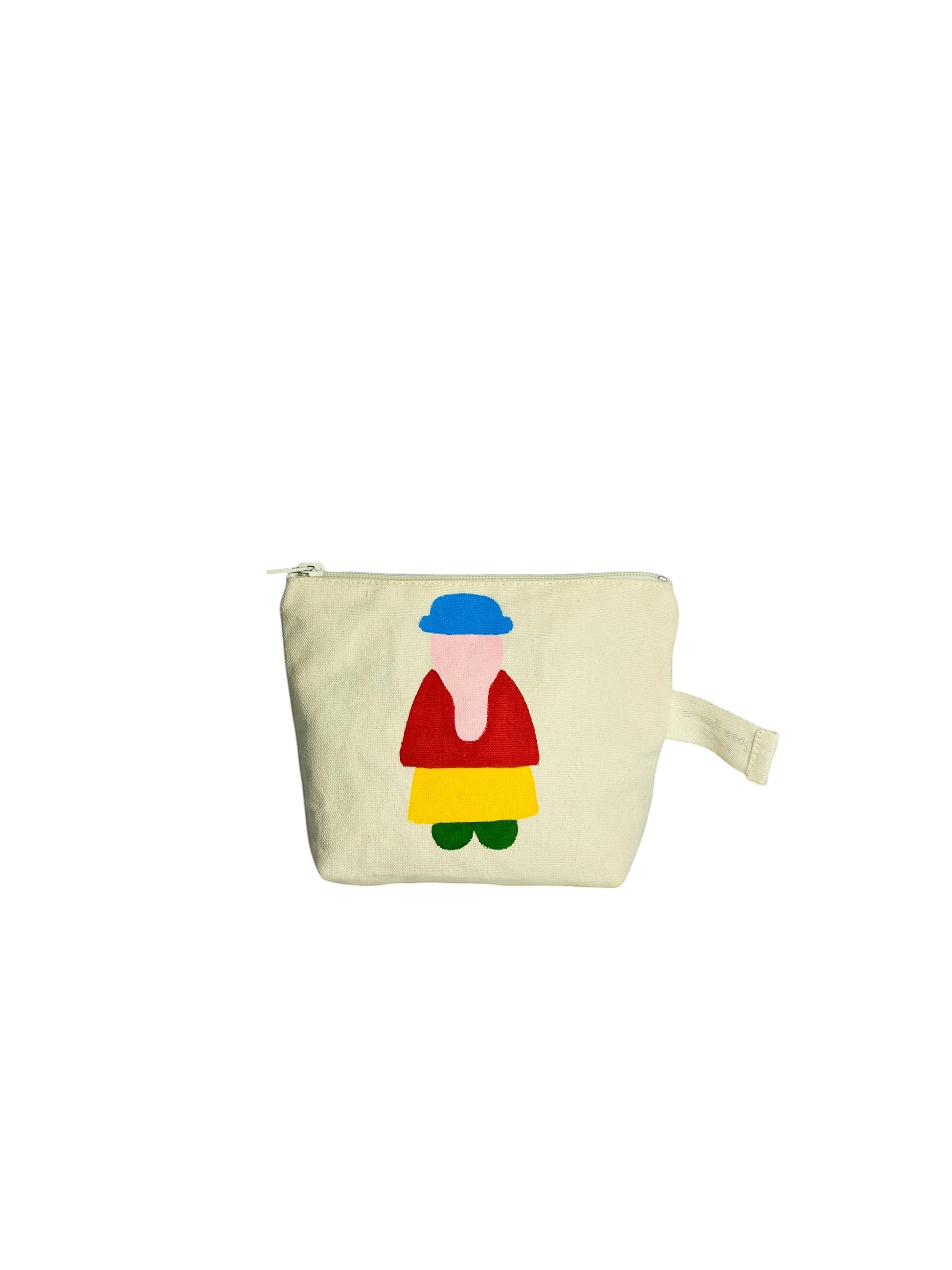 Jose Ibarra Estudio cream canvas cosmetic bag with hand-painted colourful figure design. Features a blue hat, red top, yellow skirt, and green shoes.