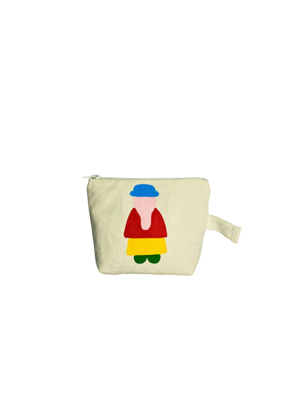 Jose Ibarra Estudio cream canvas cosmetic bag with hand-painted colourful figure design. Features a blue hat, red top, yellow skirt, and green shoes.