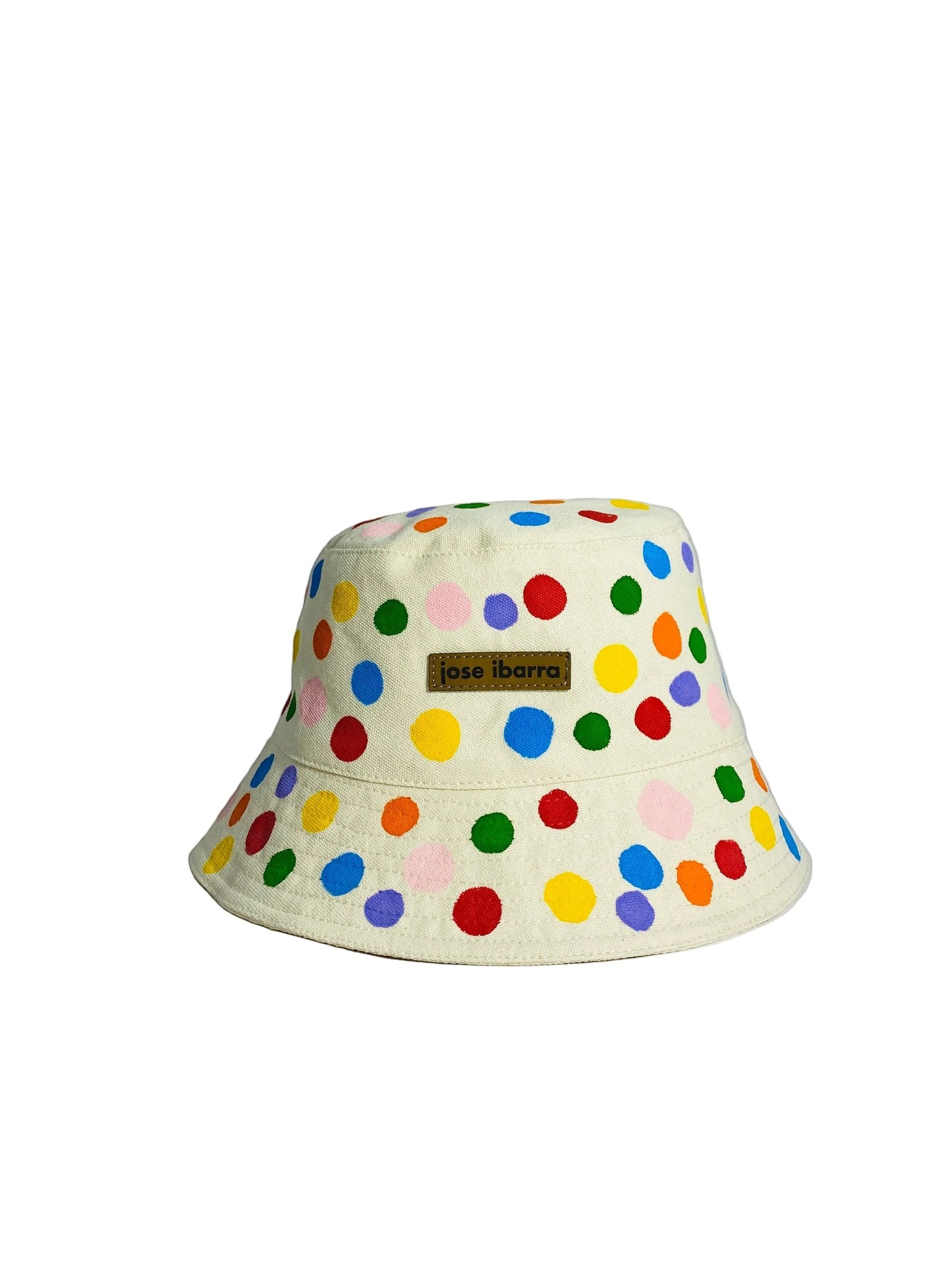 Jose Ibarra Estudio cream cotton bucket hat with hand-painted rainbow polka dots and internal cotton lining.