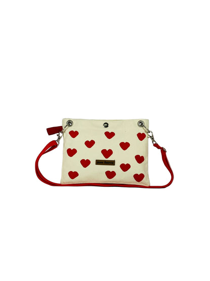 Jose Ibarra Estudio cream canvas pouch with red hearts, red trim, and red strap. Includes internal lining.