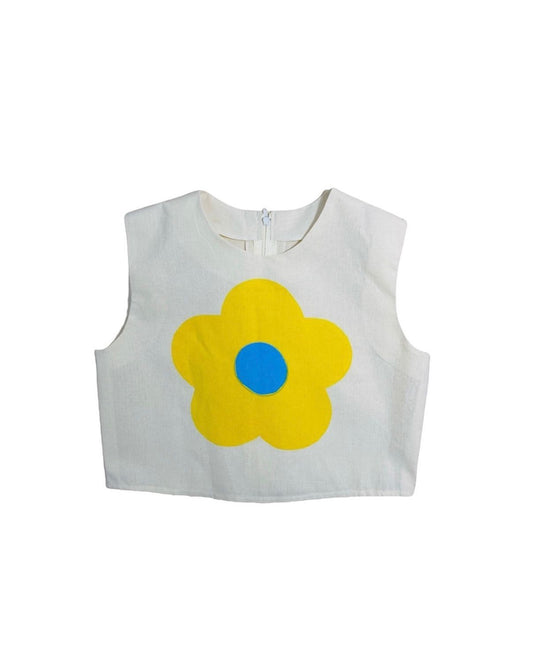Jose Ibarra Estudio cream 100% cotton sleeveless crop top with a large yellow flower and blue center, hand-painted.