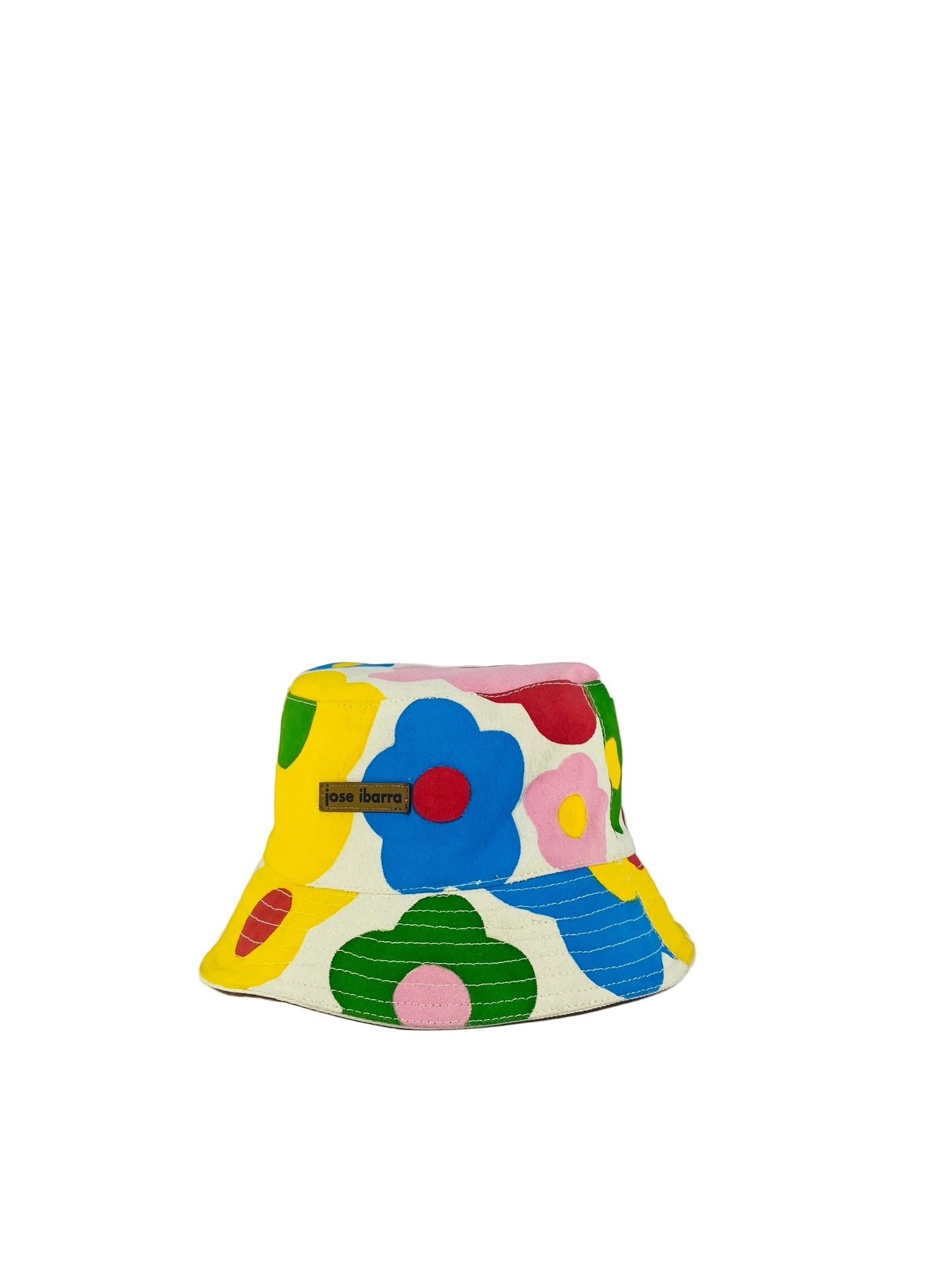 Jose Ibarra cream cotton bucket hat with a colorful hand-painted floral pattern. Features a wide brim and internal cotton lining.