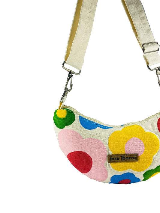 Jose Ibarra Luna cream canvas crossbody bag with hand-painted colorful floral pattern and adjustable strap.