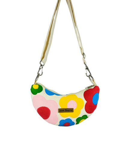 Jose Ibarra Luna cream canvas crossbody bag with hand-painted colorful floral pattern and adjustable strap.